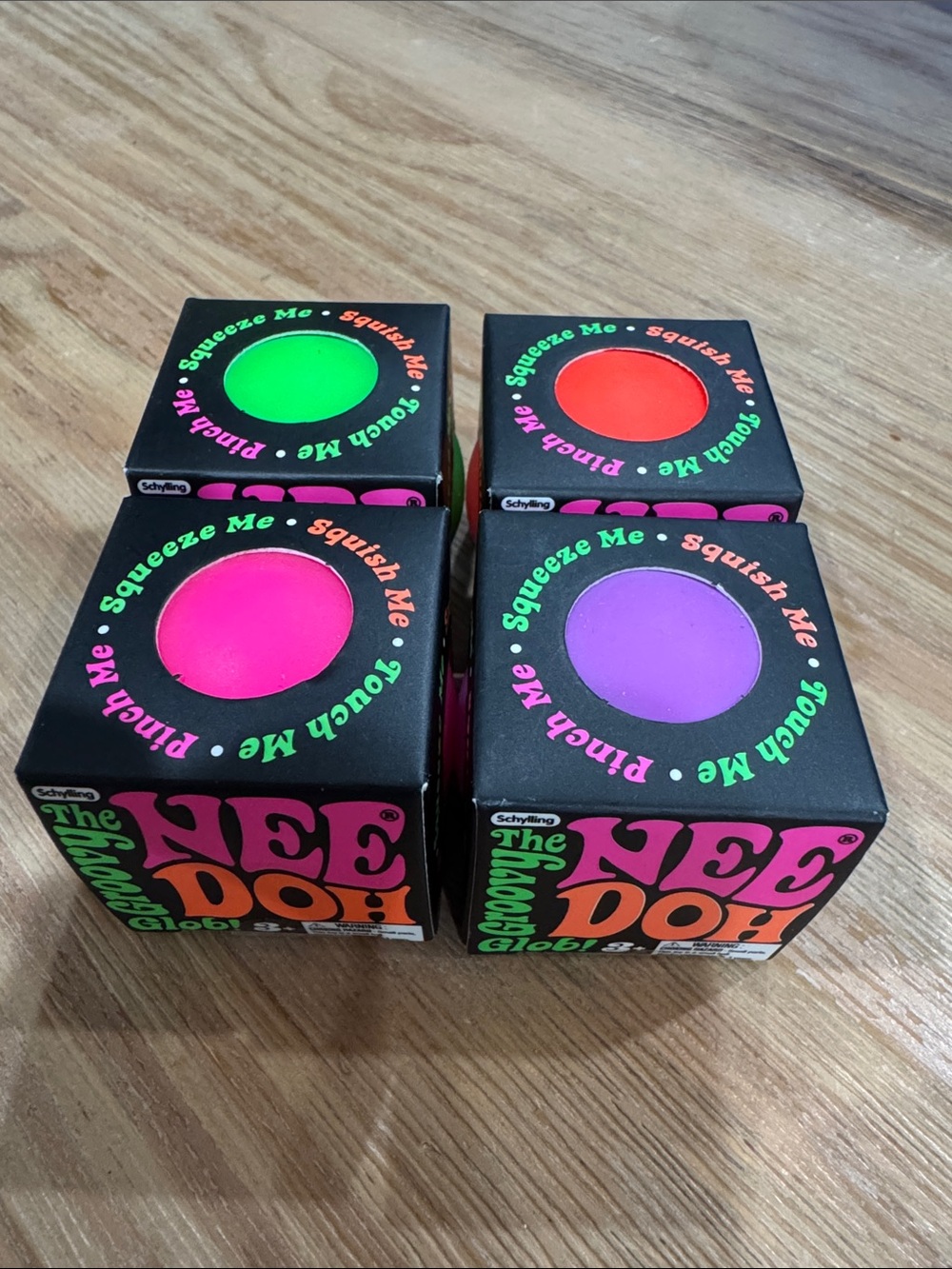 The Nee Doh Groovy Globe Stress Toy Minis - Neon Purple, Green, Orange, Pink